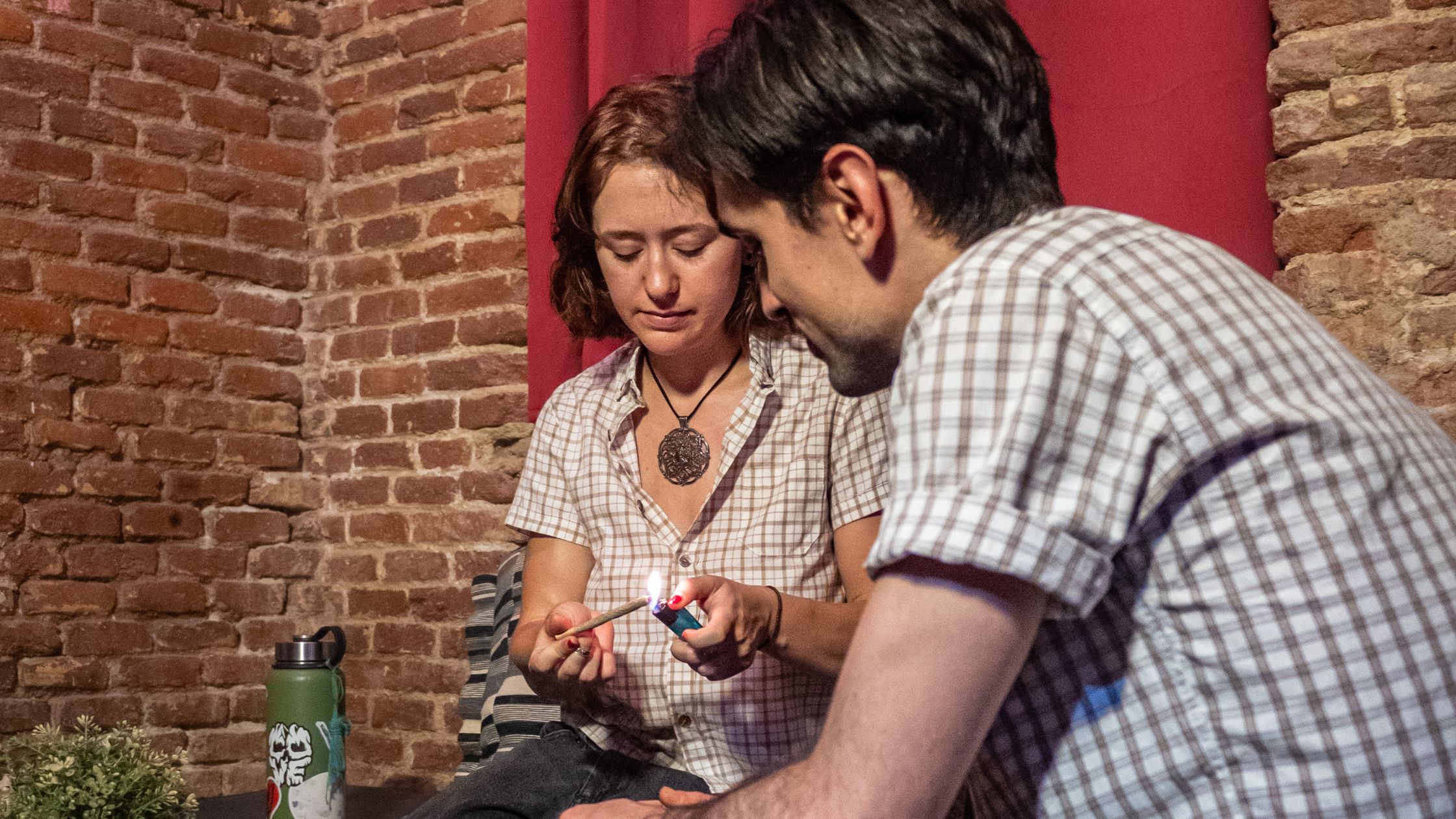 American coupe visiting a cannabis club in Malasaña Madrid smoking a joint