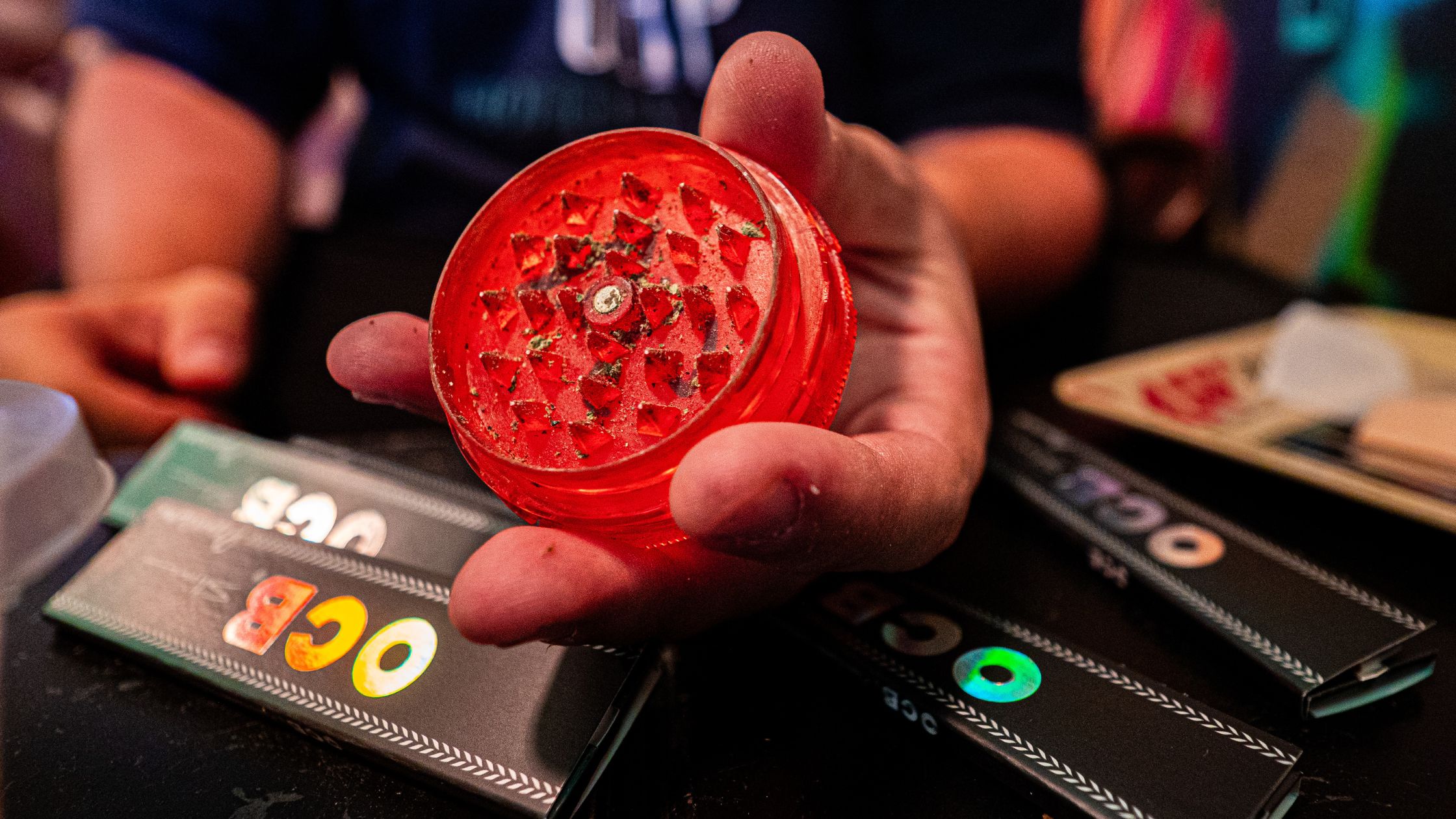 OCB rolling papers with a red grinder at a cannabis club in Madrid